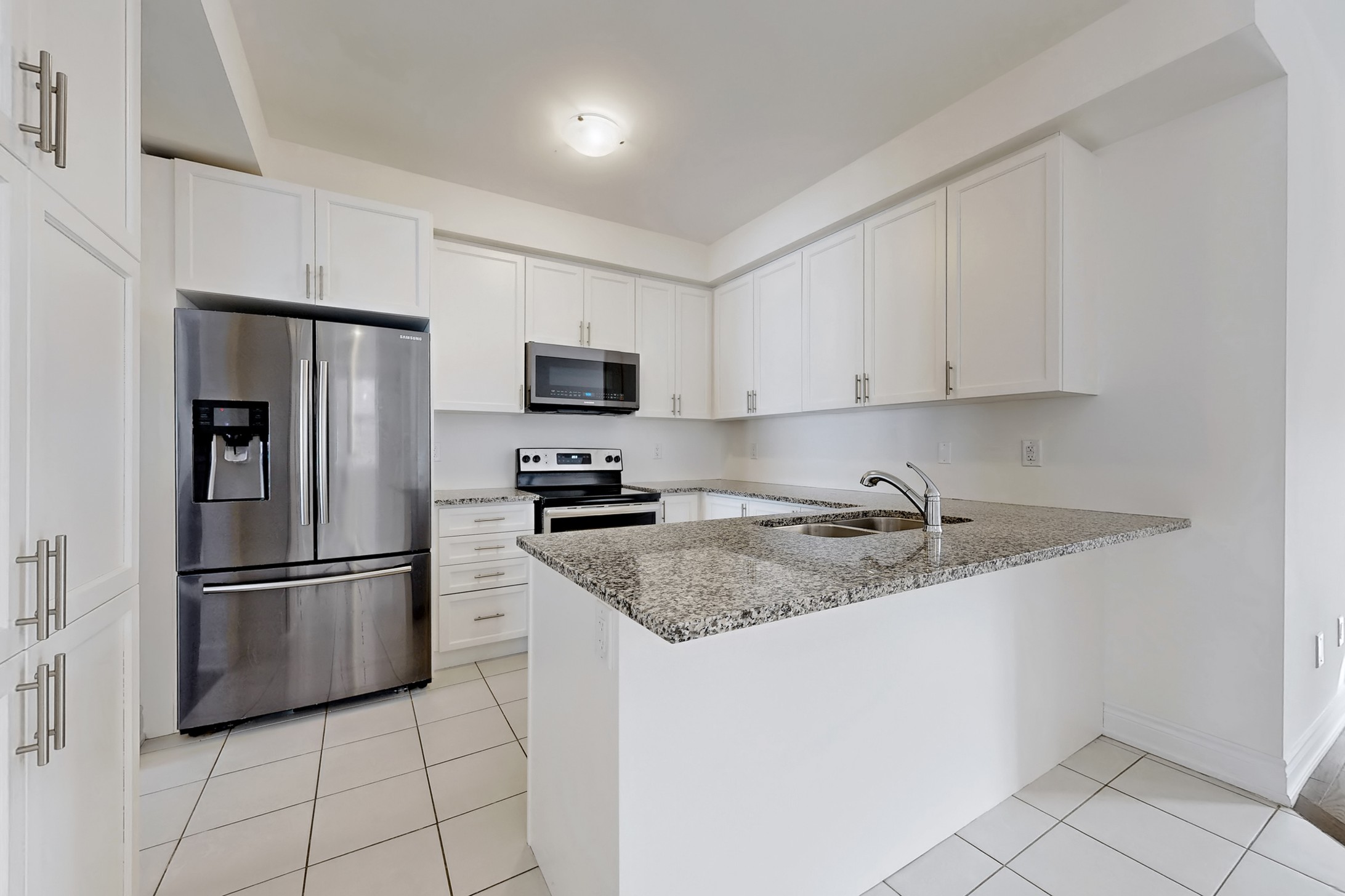 Contemporary kitchen with granite counters and stainless steel appliances