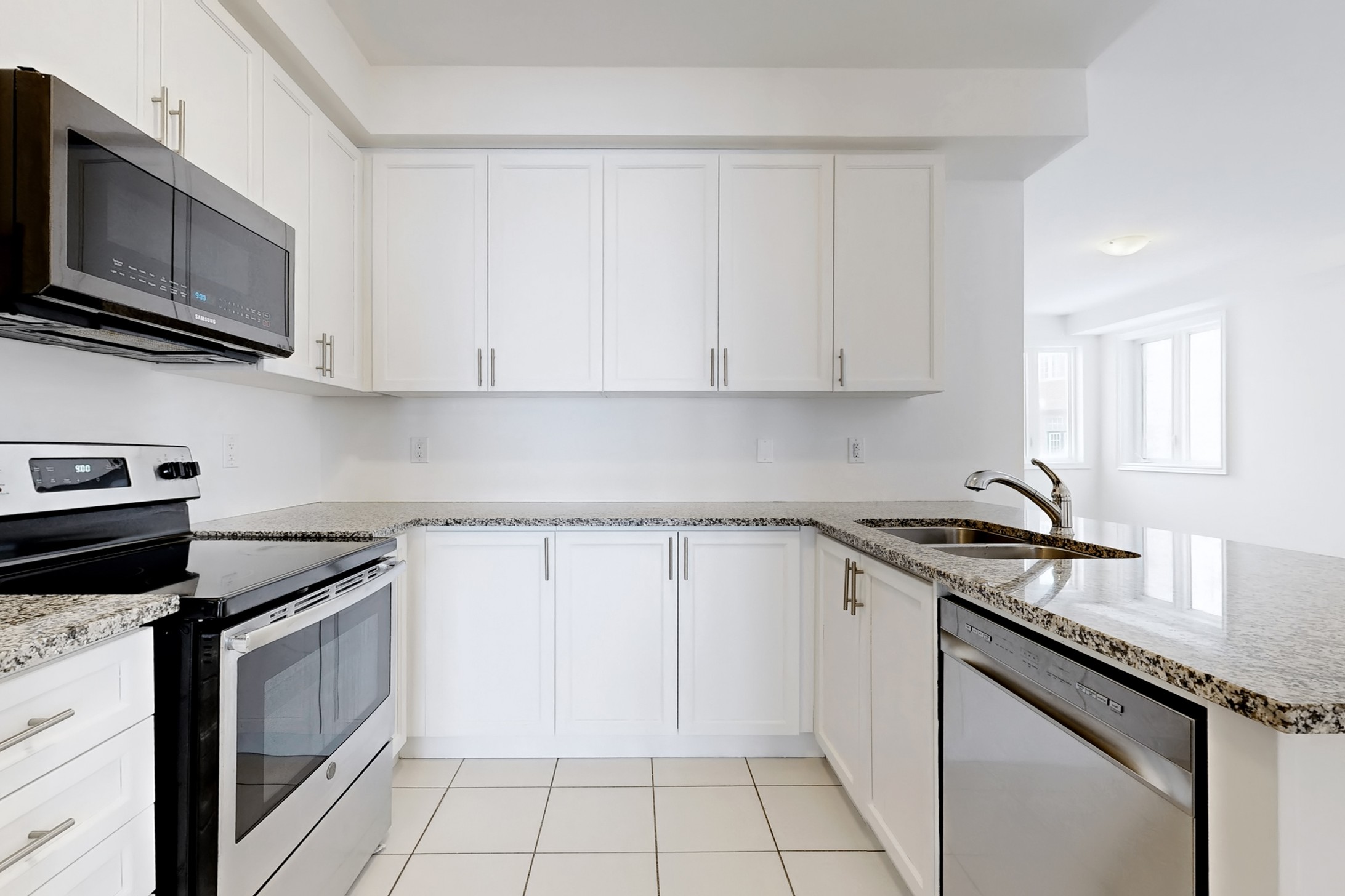 Kitchen with white cabinetry and granite countertops