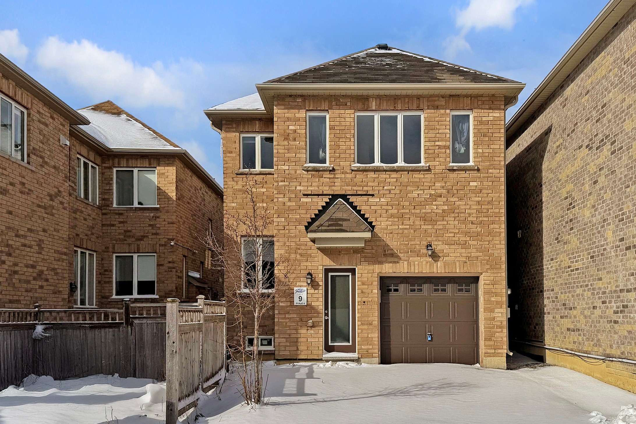 Rear view of home showing garage and yard